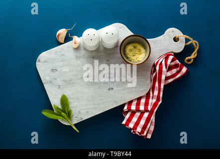 empty served plate on marble serving board and blue spice background Stock Photo