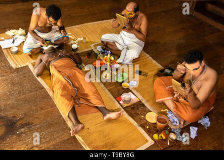 Horizontal aerial view of Kathakali performers putting on their distinctive make up in Kerala, India. Stock Photo