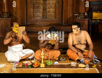 Horizontal view of Kathakali performers putting on their distinctive make up in Kerala, India. Stock Photo