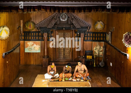 Horizontal aerial view of Kathakali performers putting on their distinctive make up in Kerala, India. Stock Photo