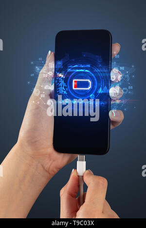 Elegant hand charging smartphone with global report concept  Stock Photo