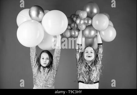 Happiness and cheerful moments. Carefree childhood. Start this party. Sisters organize home party. Having fun concept. Balloon theme party. Girls little siblings near air balloons. Birthday party. Stock Photo