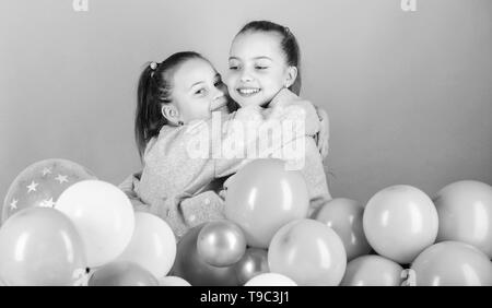 Balloon theme party. Girls best friends near air balloons. Birthday party. Happiness and cheerful moments. Carefree childhood. Start this party. Sisters organize home party. Having fun concept. Stock Photo