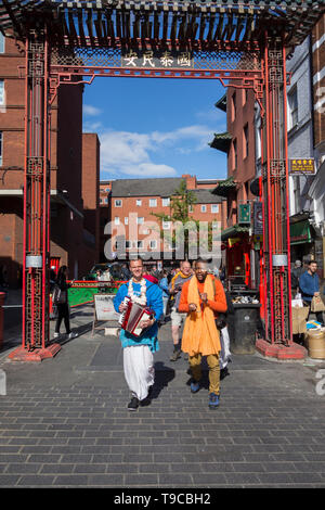 Hare Krishna followers and devotees making music and chanting in London's China Town, Soho, London, UK Stock Photo