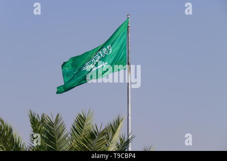 The flag of the Kingdom of Saudi Arabia waving on a flagpole Stock Photo