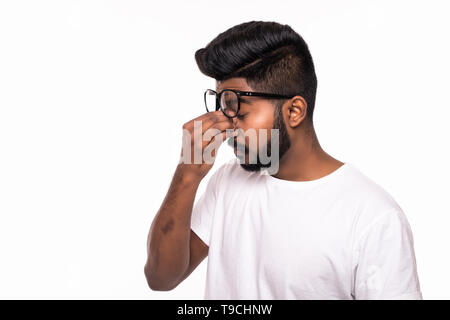Studio shot of young stressed Indian man having headache Stock Photo