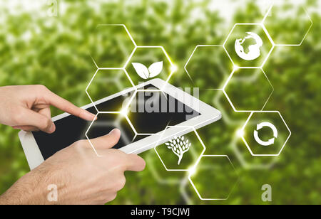 Male hand using digital tablet, virtual icons of farming Stock Photo