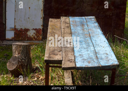 Table from old boards on the background of nature on the old farm. Stock Photo