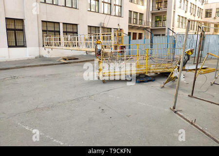 Closeup of fence and scaffolding on a background of a modern office building renovation of a building. Stock Photo