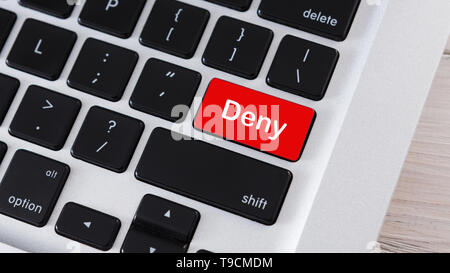 Red computer button on keyboard with text Deny Stock Photo