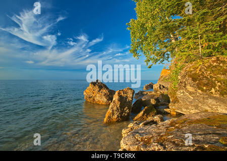 Rocky shoreline of Clearwater Lake at sunset Clearwater Lake Provincial Park, Manitoba, Canada Stock Photo