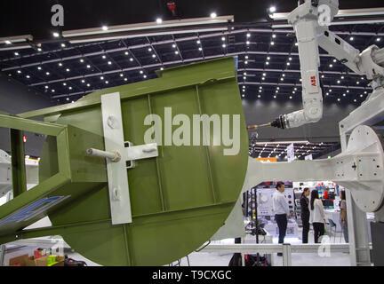 Bangkok, Thailand - May 10, 2019: Robotic welding arm welding large ventilation blower in Intermach 2019 Stock Photo