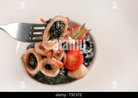 Tasty risotto with seafood on plate, closeup Stock Photo