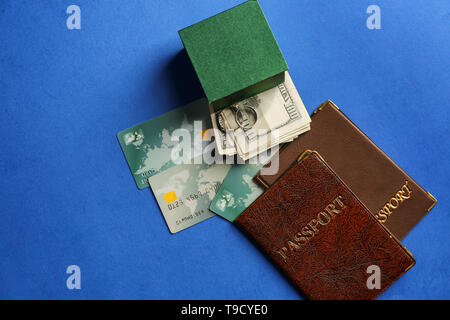 Wedding rings, money and passports on color background. Marriage of convenience Stock Photo