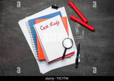 School stationery and notebook with text CASE STUDY on table, top view Stock Photo