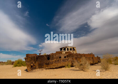 A rusted and abandoned ship is now in the sand, where once the Aral sea was. Stock Photo