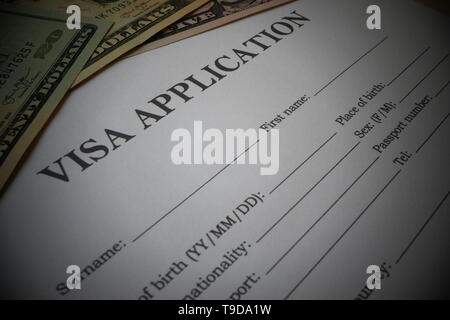 Visa application form with some US-Dollar Notes, Illustration for the payment of Visa fees from foreign citizens. Stock Photo