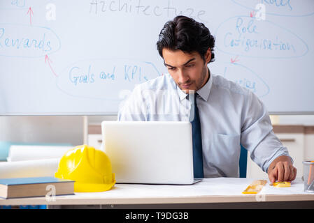 Young male architect in front of the whiteboard Stock Photo