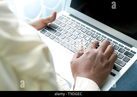 Hands of a female professional working on her laptop Stock Photo