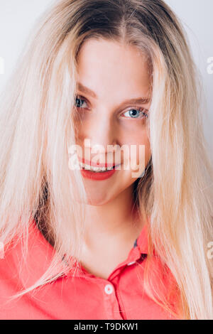 Happy cheerful young woman with clean skin, natural makeup long blonde hair wearing red dress. he smiles and looks at the camera. Closeup portrait of Stock Photo - Alamy Happy cheerful young woman with clean skin, natural makeup long blonde hair wearing red dress. he smiles and looks at the camera. Closeup portrait of Stock Photo - Alamy
