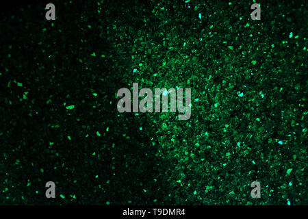 Dark abstract green background of stones and shiny crystal Stock Photo