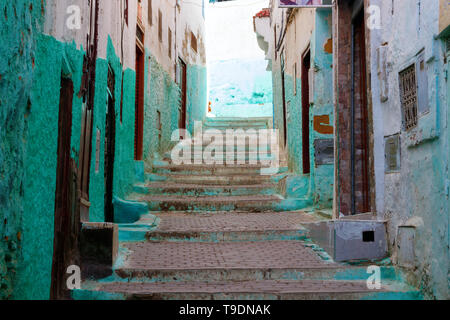 Alley in the center of the small town Moulay Idriss Zerhoun with cyan and white painted facades of houses in the afternoon, Morroco. Stock Photo