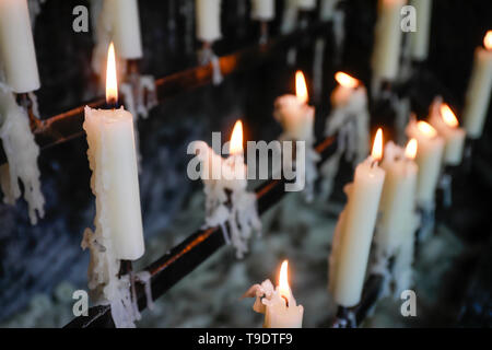 Kevelaer, Lower Rhine, North Rhine-Westphalia, Germany - Sacrificial candles burn in front of the candle chapel.  Kevelaer, Niederrhein, Nordrhein-Wes Stock Photo