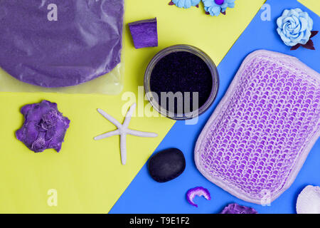 Abstract purple Spa items on colorful blue and yellow background, top view Stock Photo