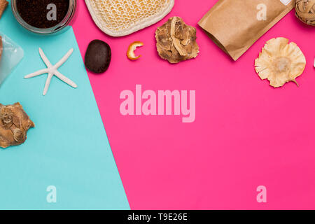 Flat lay of Spa products on colorful background copy space. Washcloth, shells, scrub and flowers on the table Stock Photo