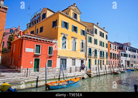 Boats along a canal in Venice. Stock Photo