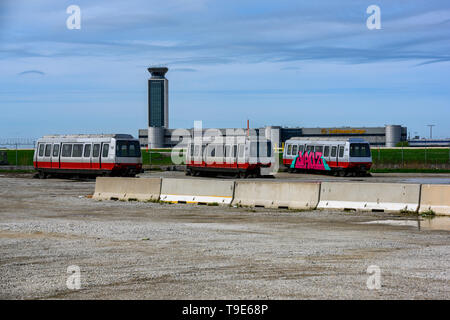 Chicago, IL, United States - May 7, 2019: Retired ATS wagons from Chicago's O'Hare Airport sitting in one of the empty lots behind the airport termina Stock Photo