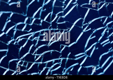 Cracked glass macro blue background high quality prints. Stock Photo