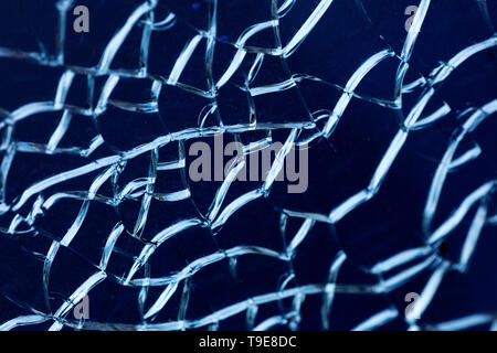 Cracked glass macro blue background high quality prints. Stock Photo