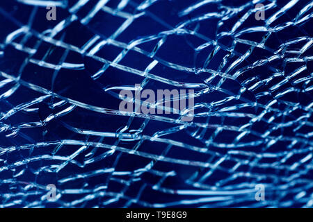 Cracked glass macro blue background high quality prints. Stock Photo