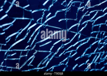 Cracked glass macro blue background high quality prints. Stock Photo