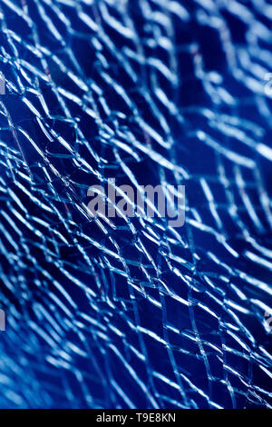 Cracked glass macro blue background high quality prints. Stock Photo