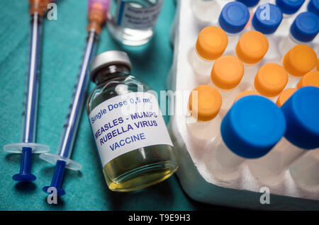 Different vials of triple viral vaccine of measles, rubella and mumps, known as MMR, conceptual image Stock Photo