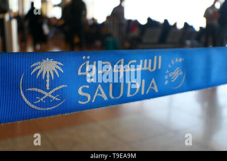 JEDDAH, SAUDI ARABIA - DECEMBER 22, 2018: A close-up view of the Logo of SAUDIA on a demarcation stand within the Jeddah International Airport Stock Photo