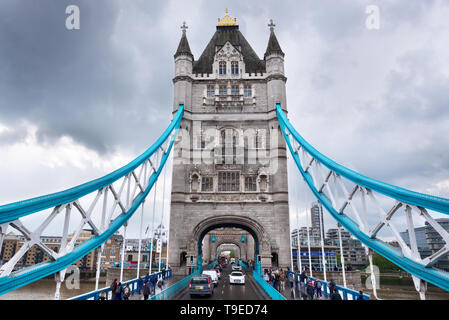London, UK - May 11, 2019: view on road through Tower Bridge from double decker Big Bus tour boat, second floor, people, suspension rods, tower . Stock Photo