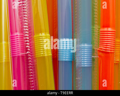 Many multicolored plastic straws. Close up macro. Plastic straws are being banned in various countries around the world. Stock Photo
