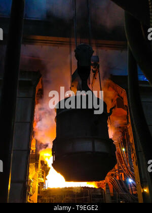 Smelting of metal in big foundry. Iron and steel production at a metallurgical plant. Steel worker. Metallurgy process. Stock Photo