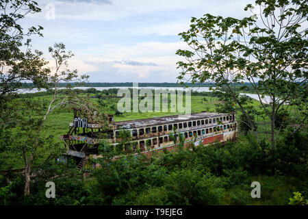Abandoned ferry or lancha on the outskirts of Iquitos with the Amazon River in the background, Maynas Province, Loreto Department, Peru Stock Photo