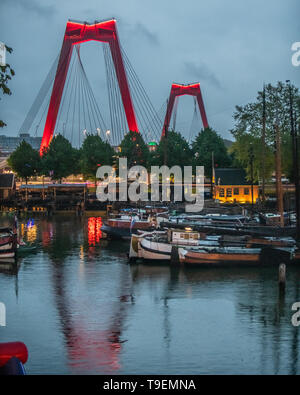 Old Harbor Rotterdam with Willemsbrug bridge reflection - red bridge Rotterdam over the Nieuwe Maas river Stock Photo