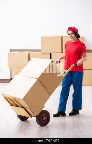 Young female professional mover doing home relocation Stock Photo