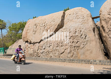 Man on motorcycle in front of Unfinished Relief Carving, Mahabalipuram (Mamallapuram), India Stock Photo