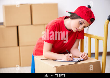 Young female professional mover doing home relocation Stock Photo