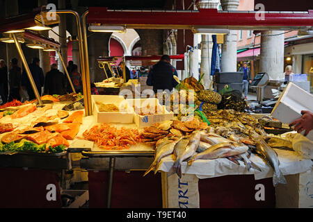 VENICE, ITALY -8 APR 2019- Fresh seafood for sale at the Rialto farmers market (Mercato di Rialto) in Venice, near the Rialto Bridge and the Grand Can Stock Photo