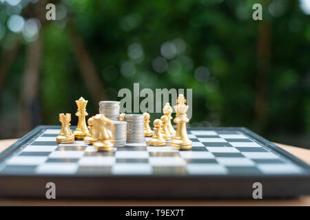 stacked coins on a chess board. conceptual photography on the game in stock market - Image Stock Photo
