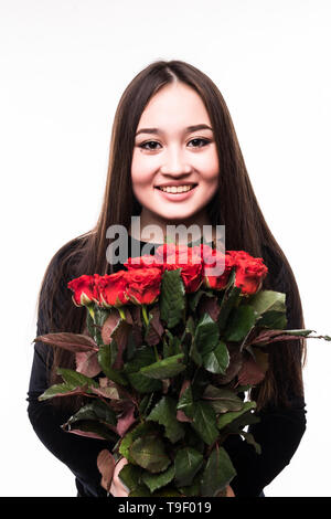 An isolated shot of an asian girl holding a bouquet of red roses celebrating Valentine day Stock Photo