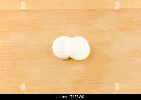 very large round white tablets on a wooden background Stock Photo